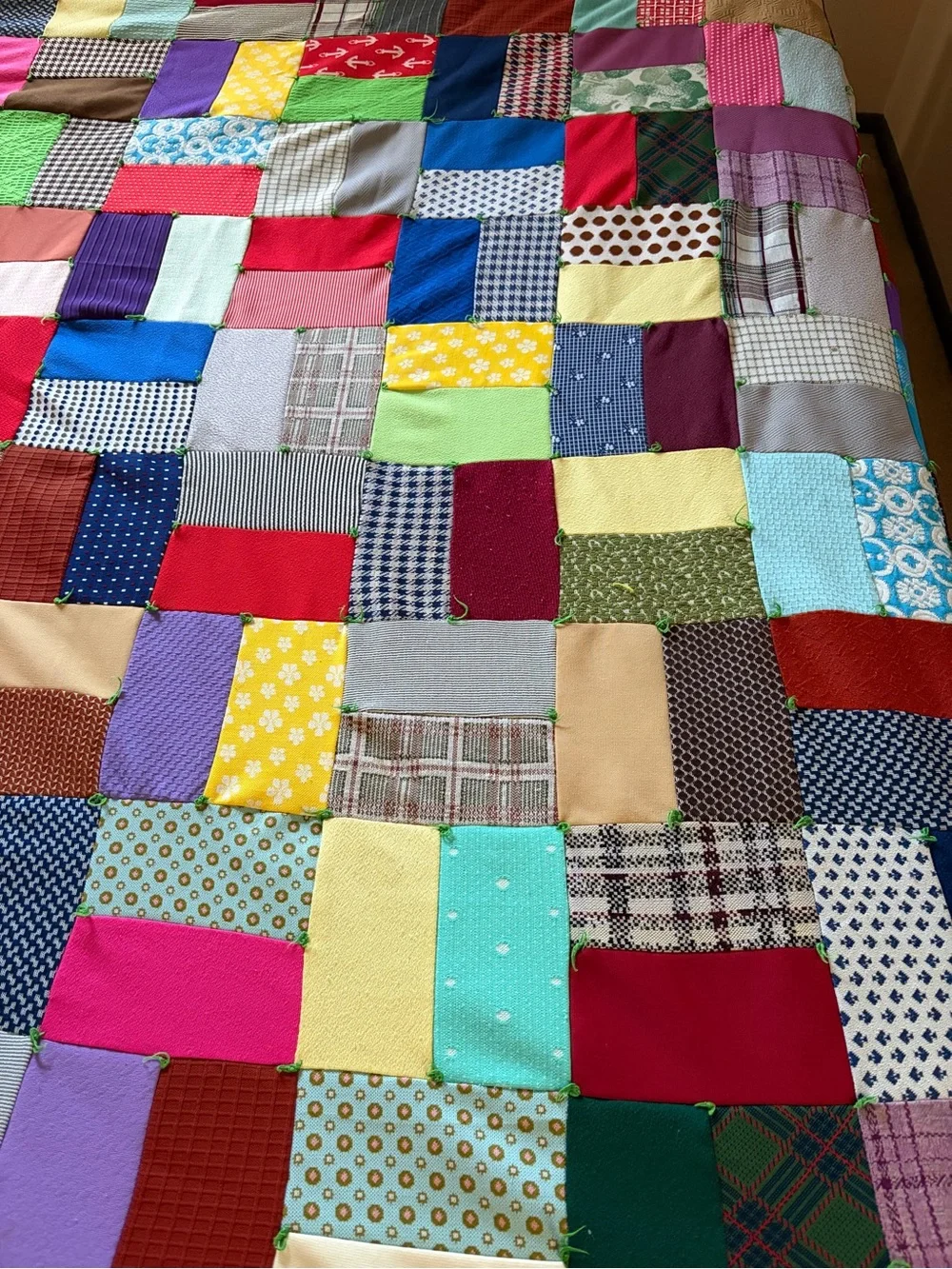 Vintage hand tied Multicolor Patchwork with solid green backing.